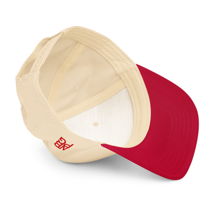 Red and natural 5-panel baseball cap from Not Bad Pretty Good featuring a mid-profile golf hat design with "Lip-N-Out Bogey" detail.