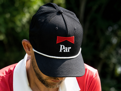 A stylish Parboro Golf Rope Hat by Not Bad Pretty Good featuring a casual design with rope accents and a wide brim.
